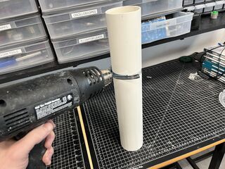 Softening the PVC with a heat gun.
