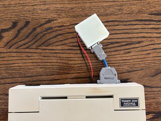 Tandy 200 connected to Zimodem module via a DB9 to 25 pin serial adapter. Another view.